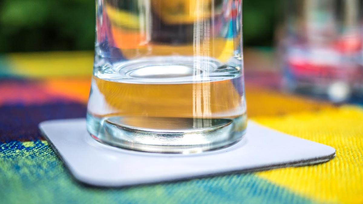 Ein Glas mit einem Magneten im Boden auf einem magnetischen Untersetzer