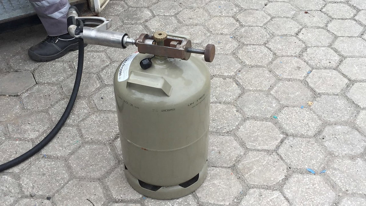 Eine graue Gasflasche in Portugal beim Befuellen
